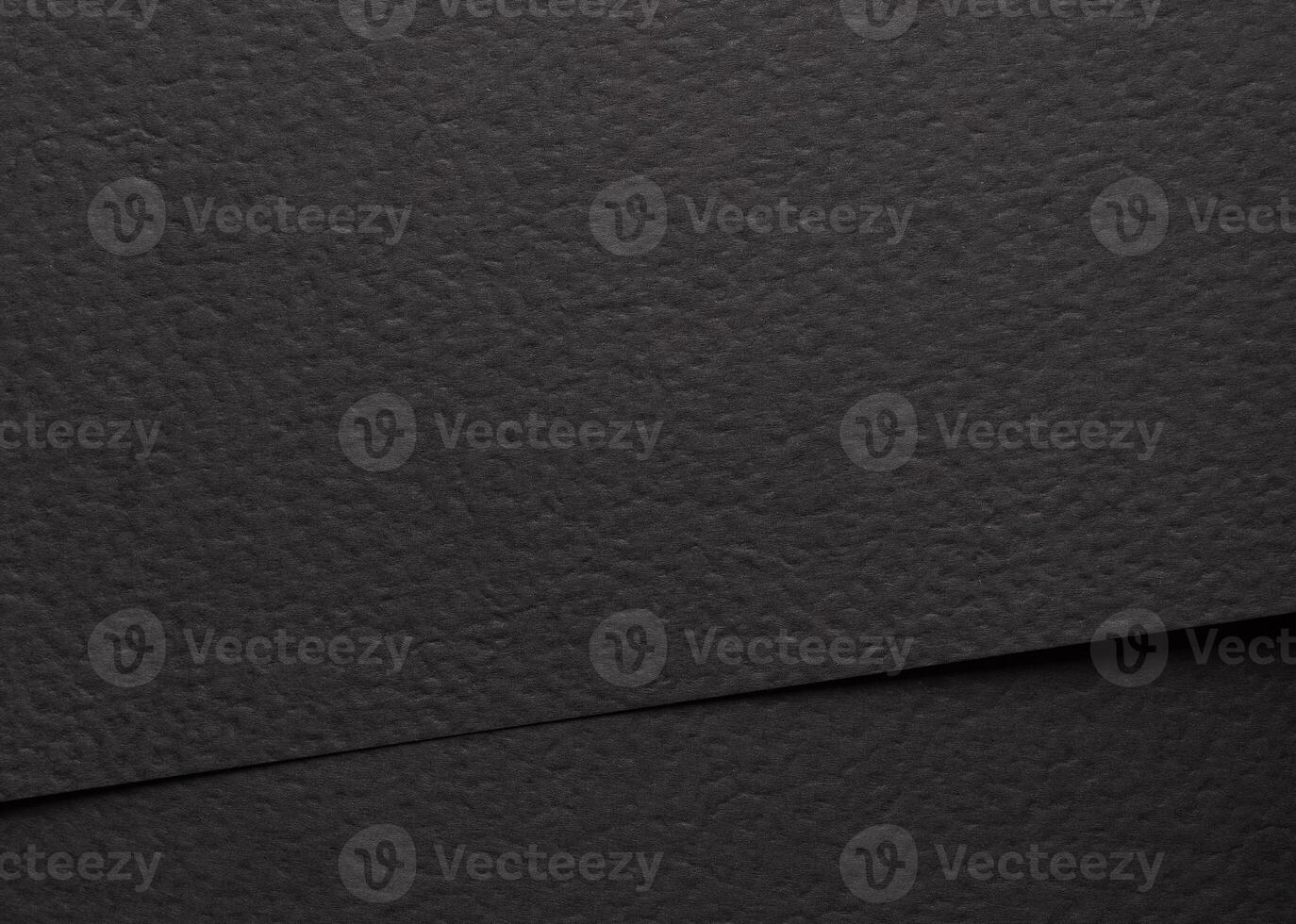 Black matte paper texture with a sleek, modern finish, featuring a minimalistic abstract design. photo