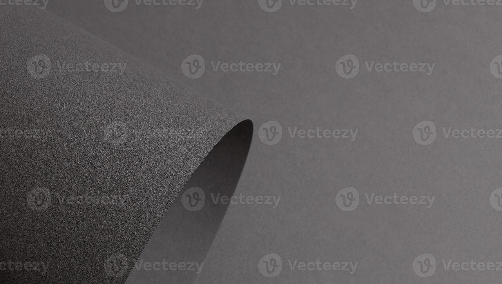Gray matte paper with a textured surface, featuring wavy folds and perforated edges. Elegant, modern photo