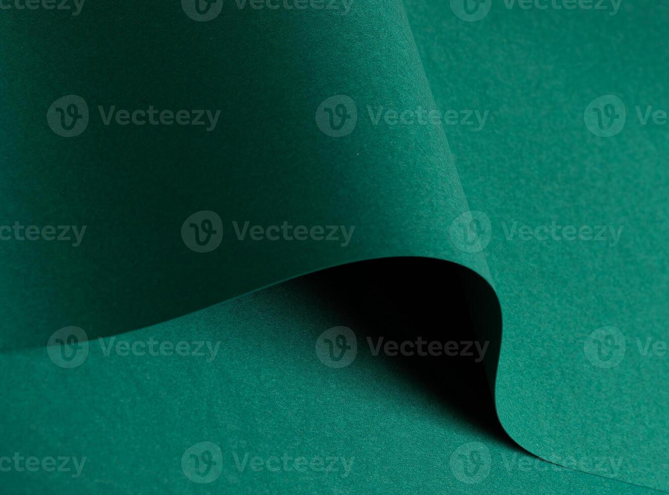 Green paper texture with vibrant emerald and jewel green tones, matte surface with curved folded photo