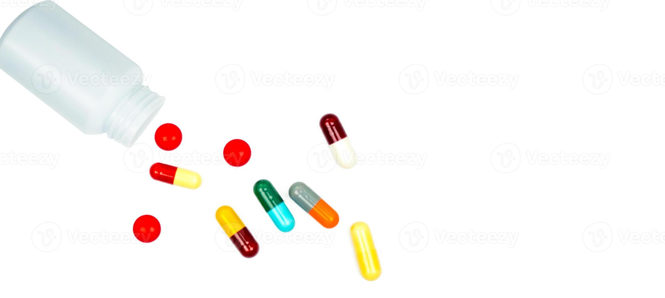 Medicine bottle with prescription pills and capsules isolated on white background. Pharmaceutical products for healthcare marketing and medical industry presentations. Antibiotic capsules and tablets. photo