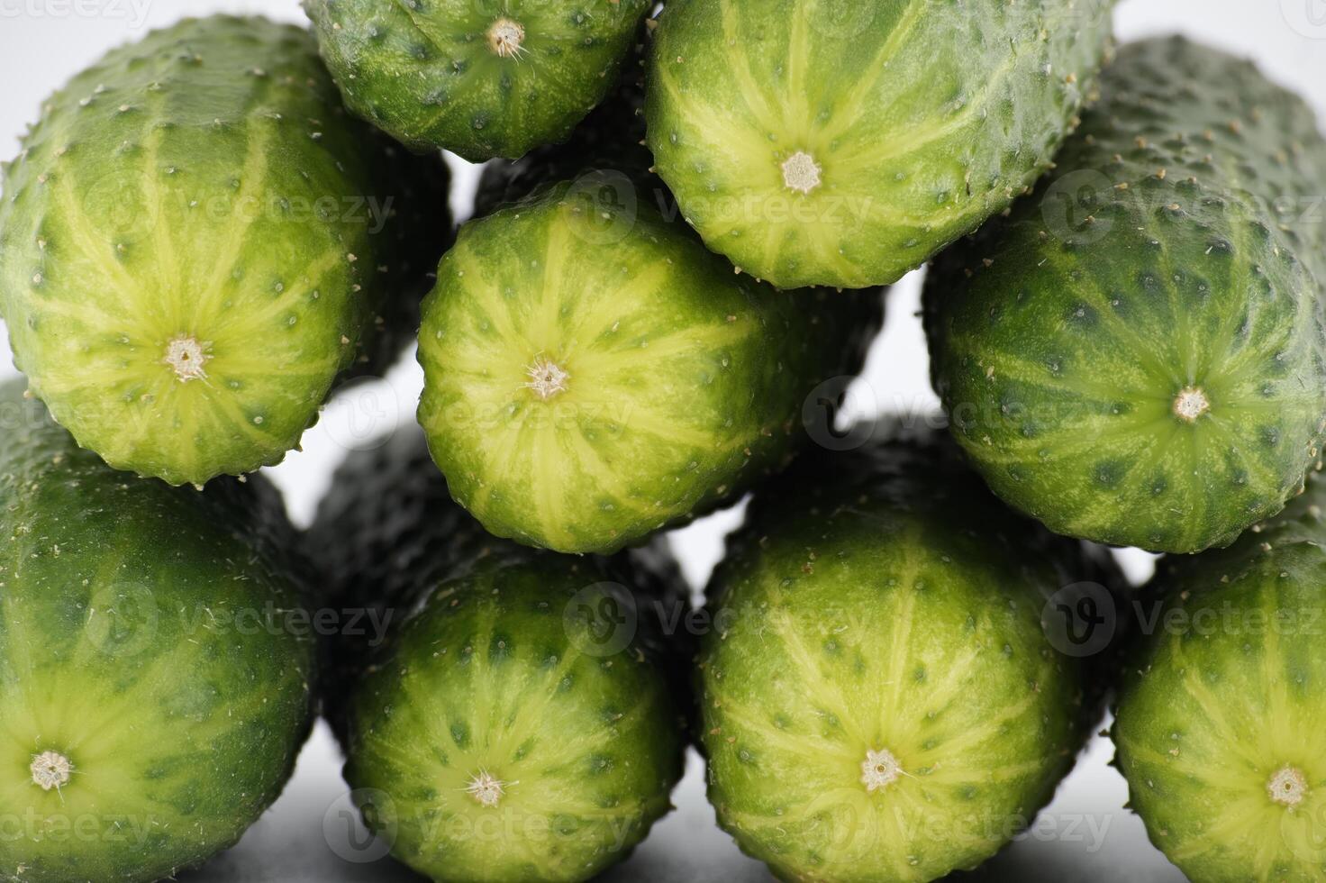 Visually appealing arrangement of fresh, green cucumbers, stacked to form a vibrant close-up image. photo