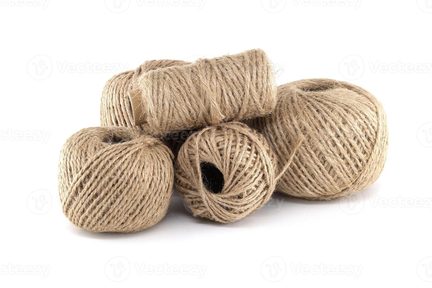 A cluster of twine balls in various sizes, showcasing natural fibers and earthy textures. photo