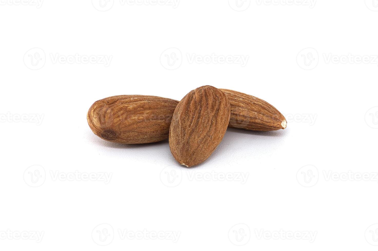 Three delicious almonds rest against a plain white background, ready for eating or cooking. photo
