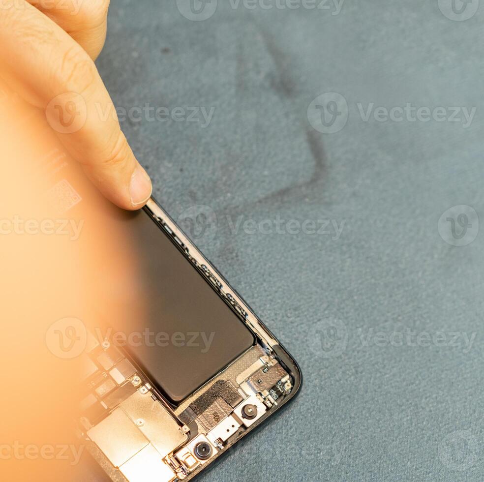 Expert Repair Technician Works on Smartphone Battery Replacement With Precision and Skill in a Clean Workspace During Daytime photo
