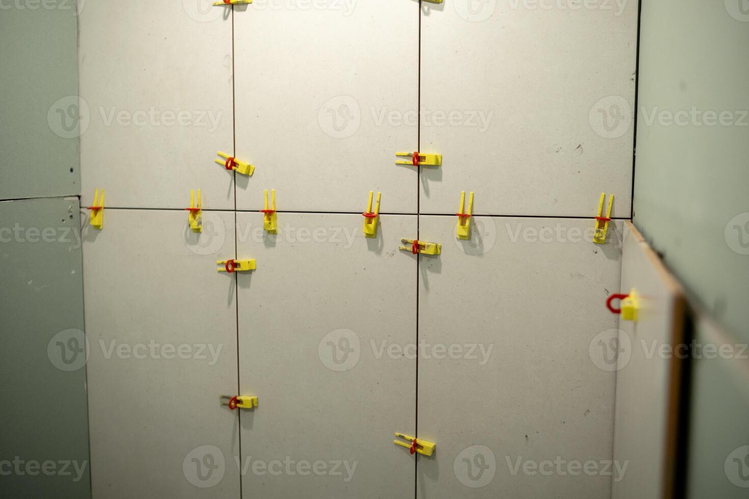 Drywall Installation Process in a Home Interior With Colorful Clips Used for Securing Panels During Alignment and Setup photo