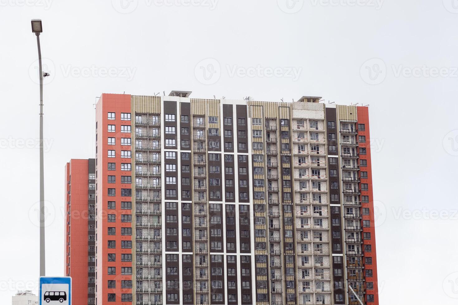 Modern Residential Building Under Construction With Scaffolding and Workers Visible During Daylight photo