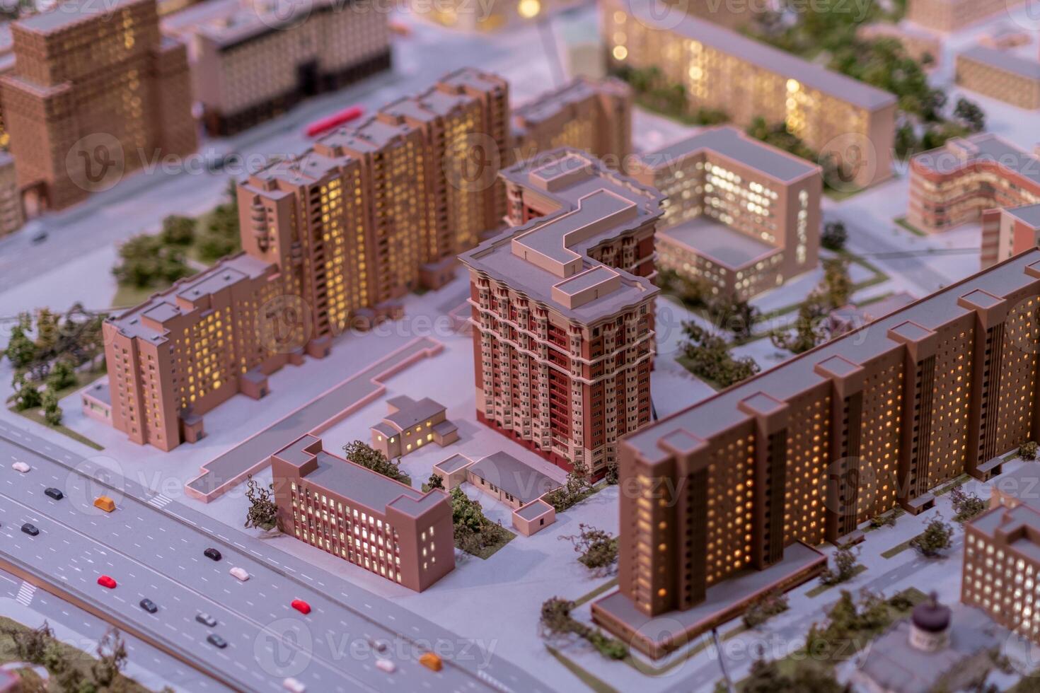 Detailed Architectural Model Showcasing a Modern Urban Development Project at Night With Illuminated Buildings in a City Setting photo