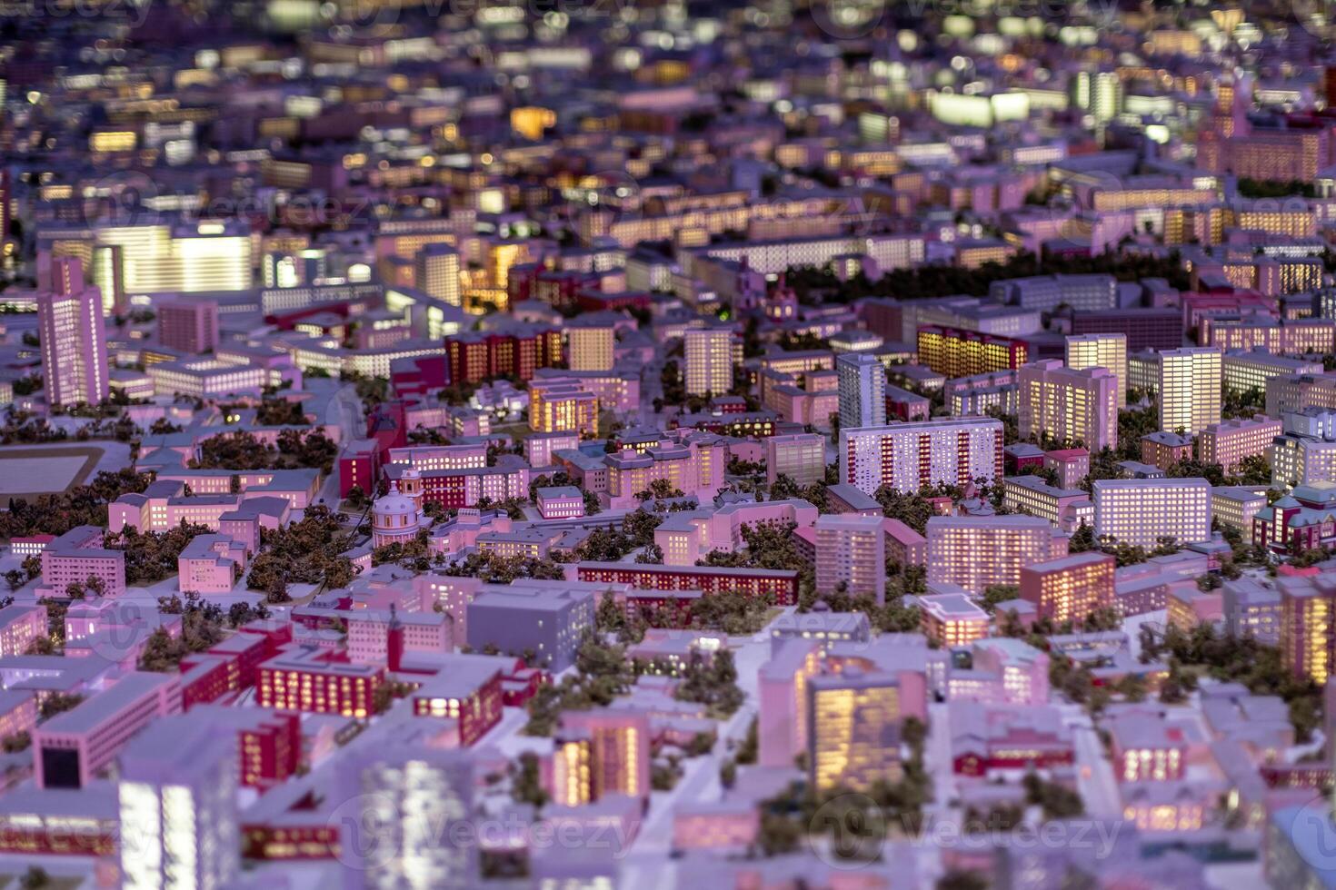 Detailed Miniature Cityscape Showcasing Urban Buildings, Streets, and Lights During Evening Hours in a Bustling Metropolitan Area photo