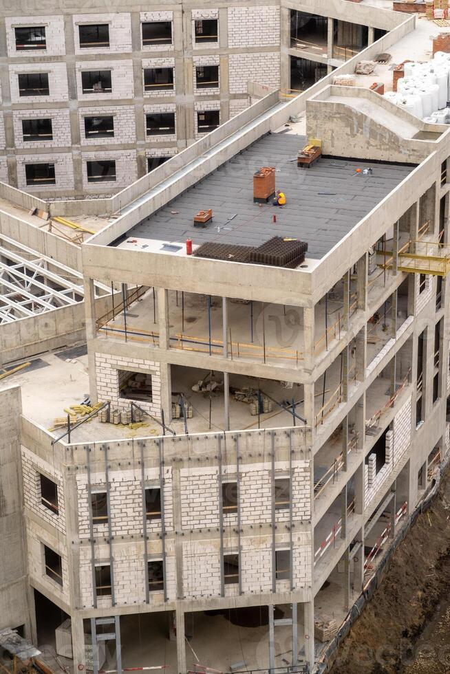 New Commercial Building Under Construction With Modern Architecture Details and Ongoing Worksite Activity in a Bustling Urban Area photo