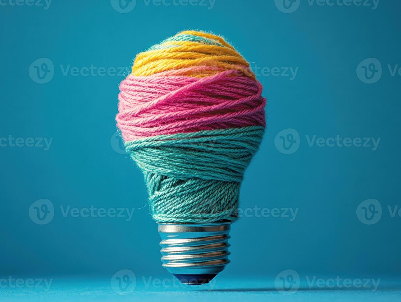 Colorful light bulb made of yarn arranged in vibrant patterns photo