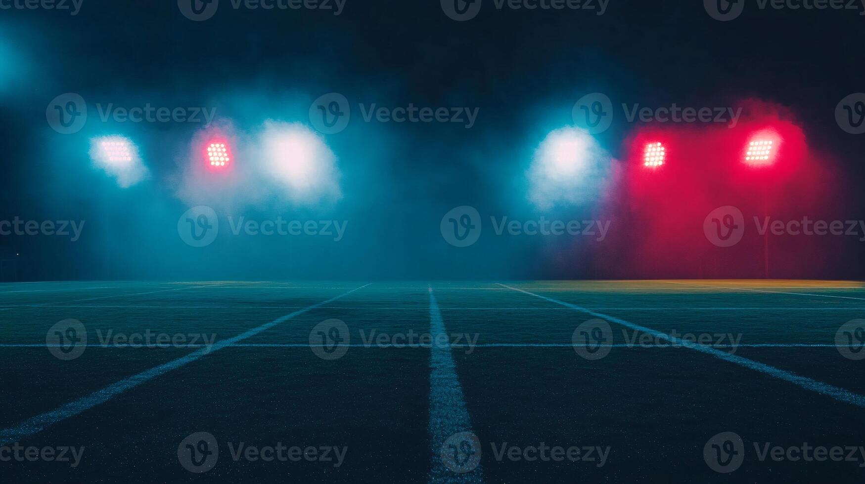 Football Field Illuminated by Bright Stadium Lights at Night photo