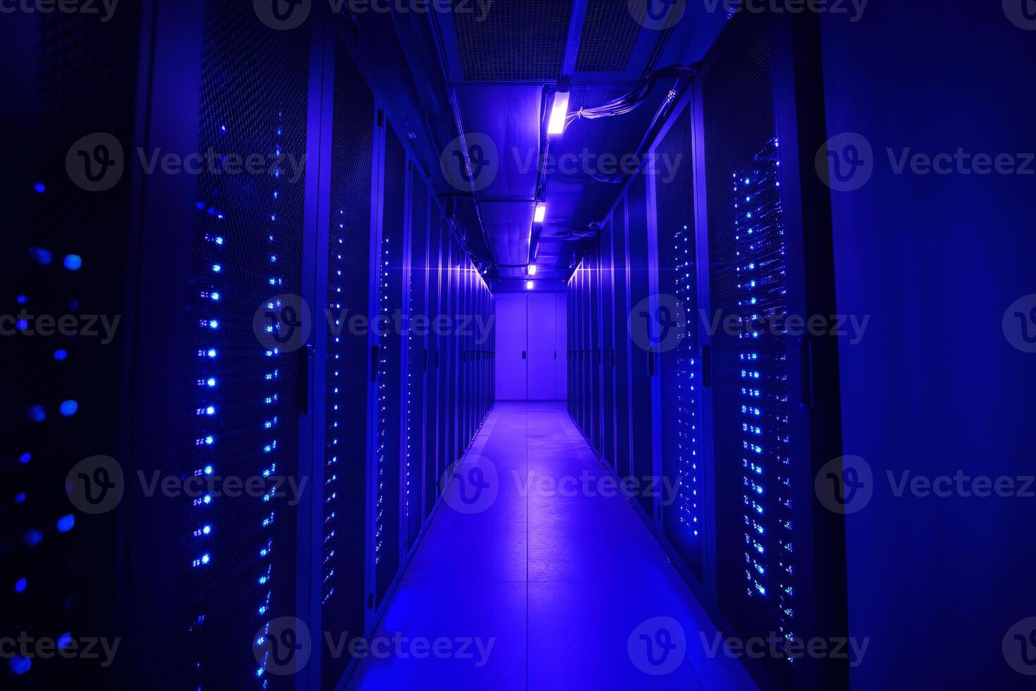 Server room illuminated by glowing blue lights and digital data streams photo