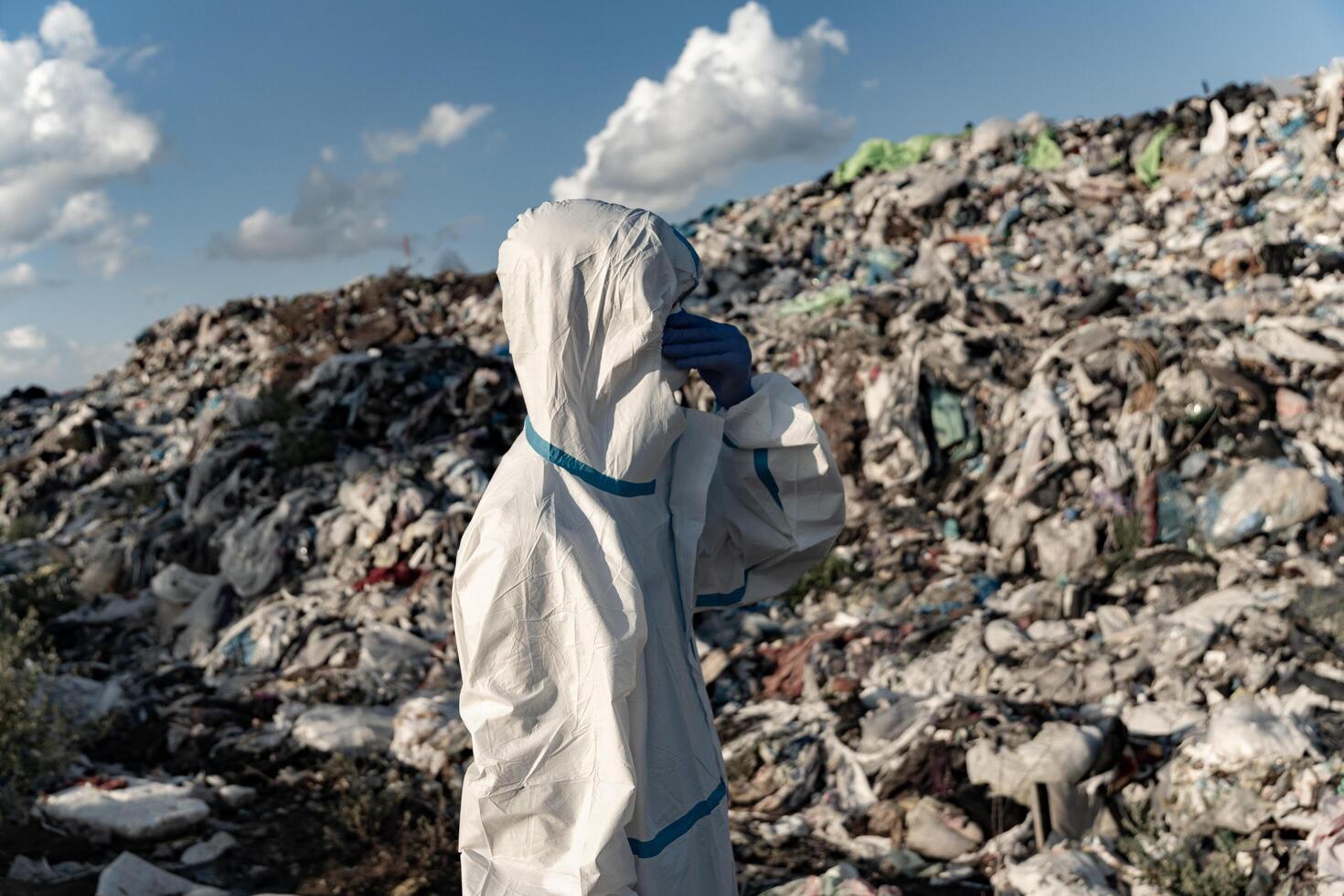 Sanitation worker at the landfill. Waste dump concept, Pile of garbage, garbage dump photo