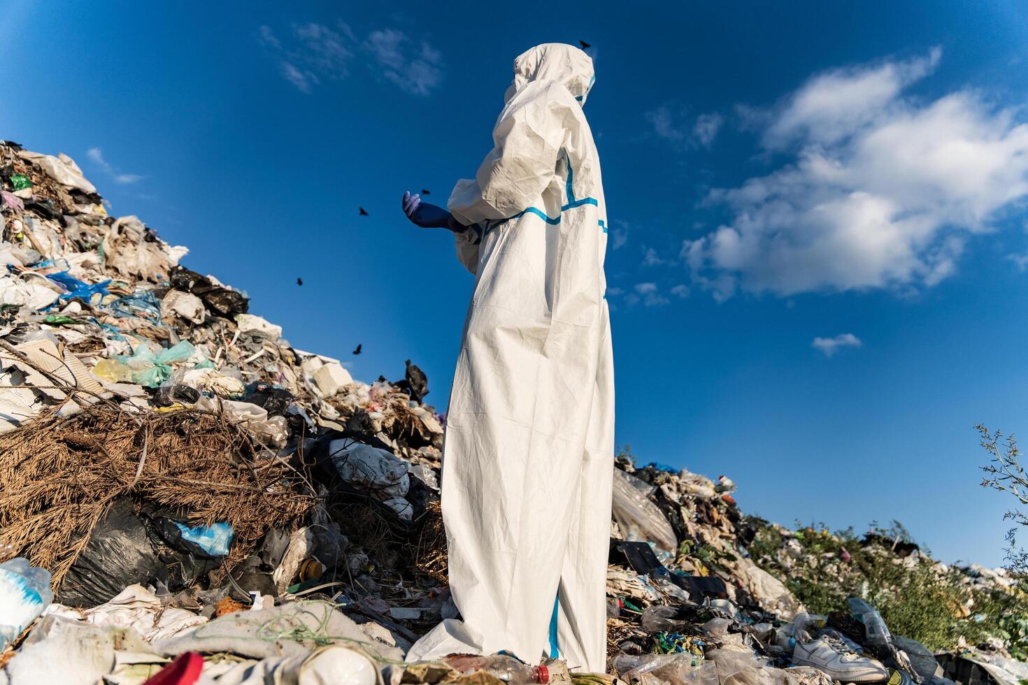 Sanitation worker at the landfill. A large landfill. Household waste at the municipal landfill. Planet pollution concept photo