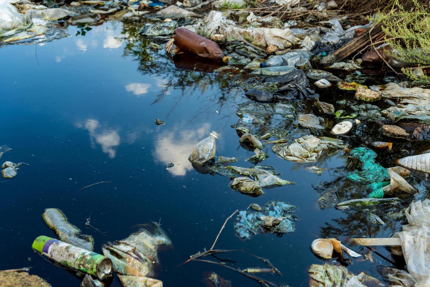 River or lake covered with floating garbage and plastic waste. Pollution from garbage causes water to become polluted. Environment pollution photo