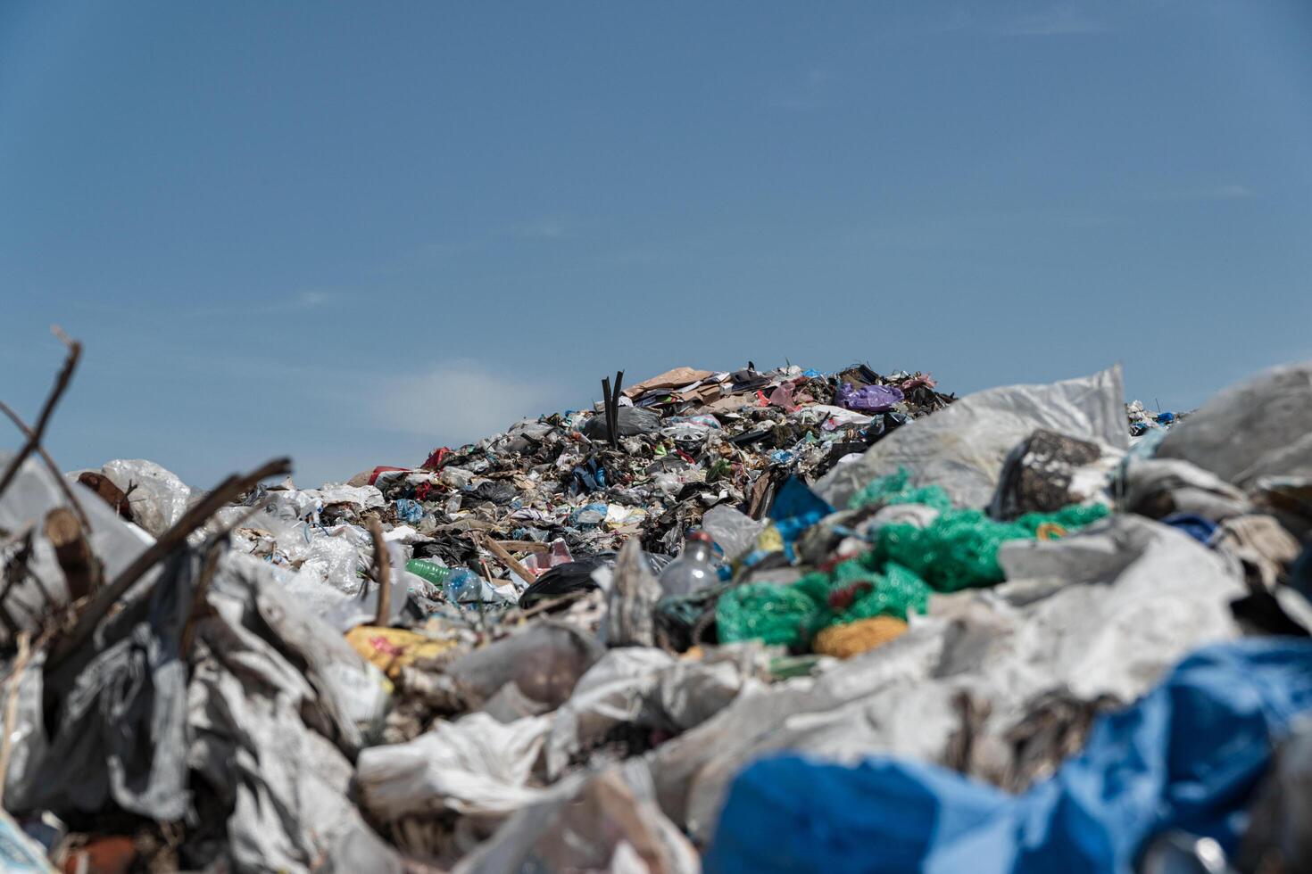 A large open-air garbage dump. Close-up of plastic waste at the landfill. Pollution of the planet with garbage photo
