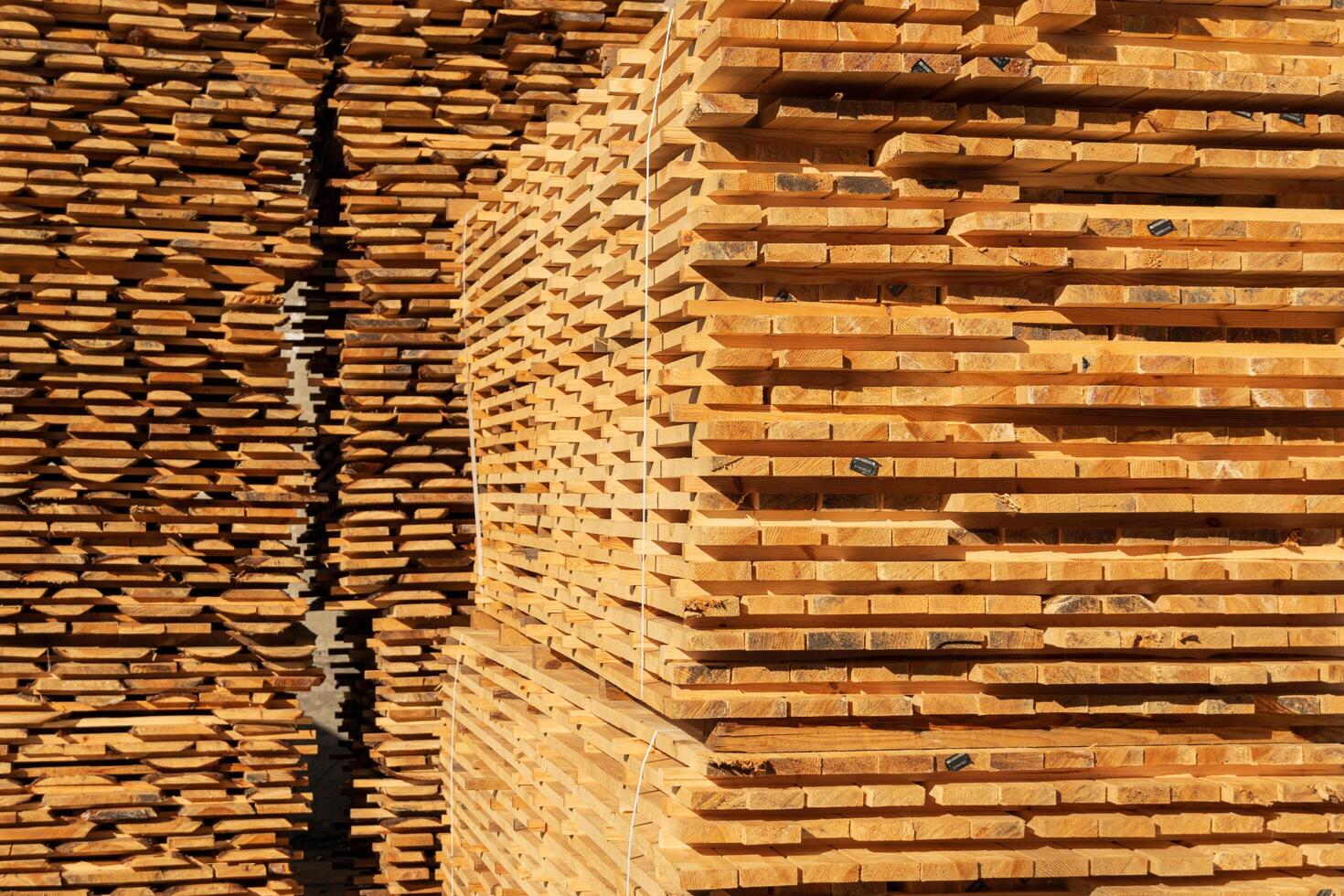 Pile of pine boards. Wood drying. Lumber. Harvesting, sale of lumber for construction photo