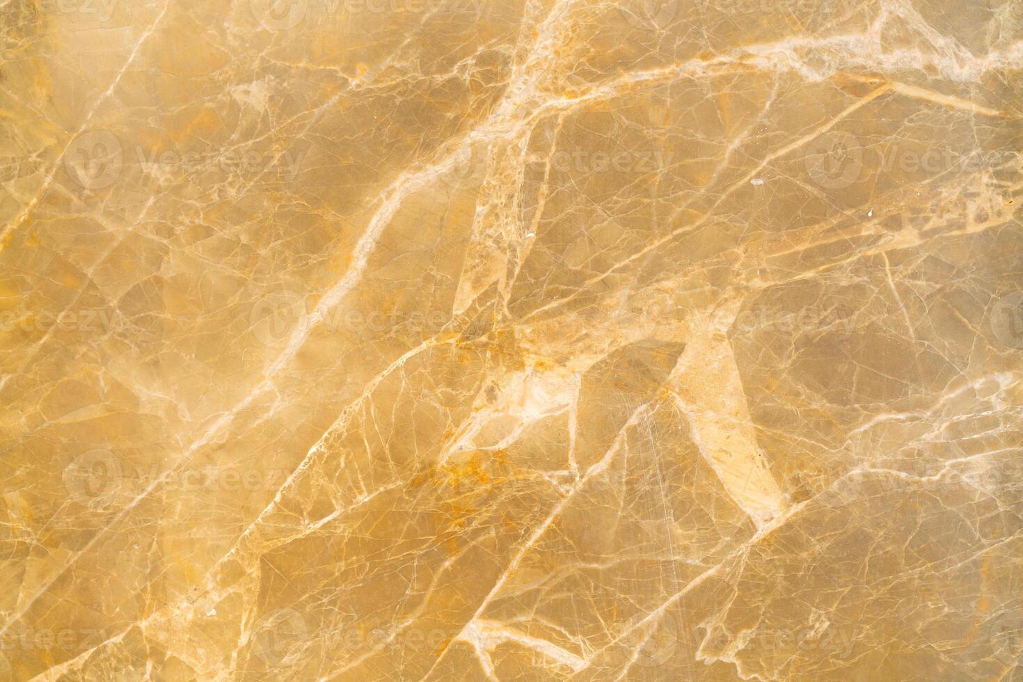 Texture of stone marble. Golden surface of marble stone with striped streaks. photo