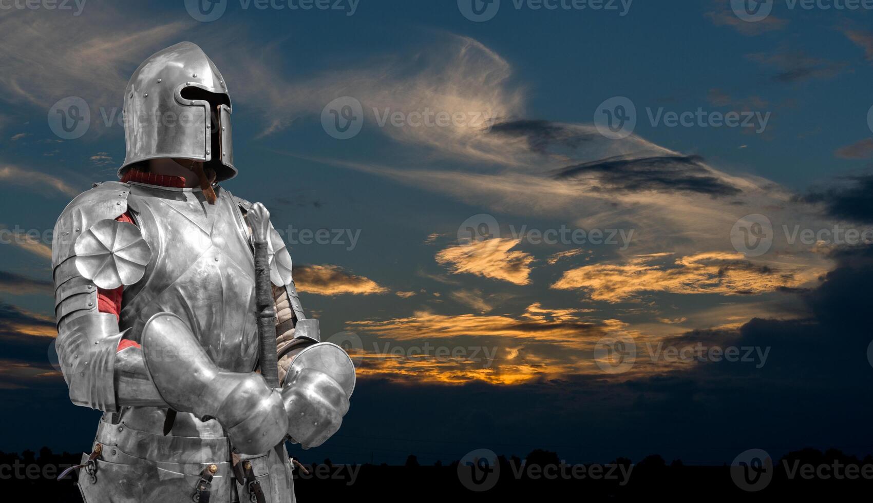 Knight in helmet and metal armor. 24-hour security. photo