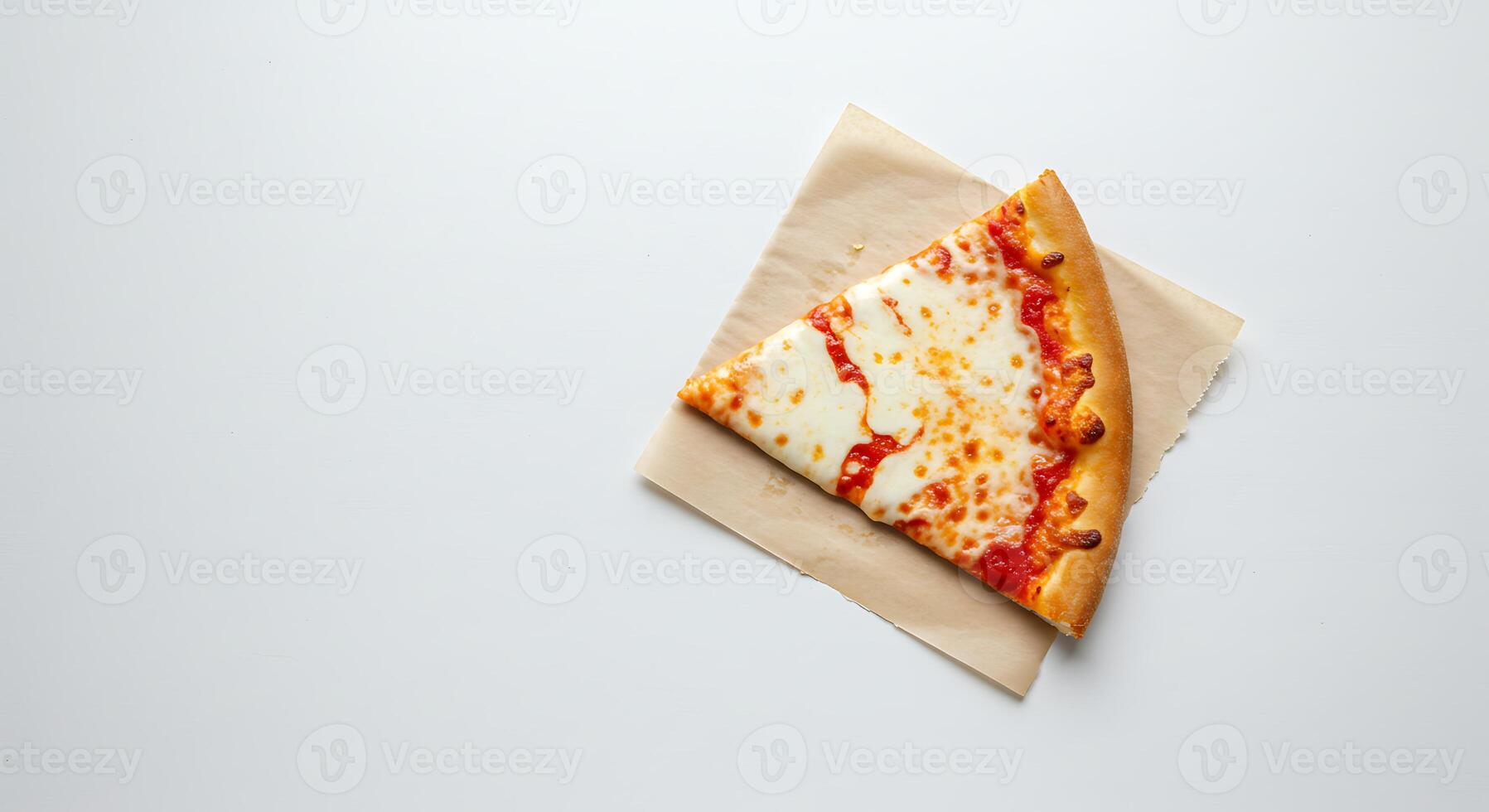A slice of pizza on a piece of paper photo