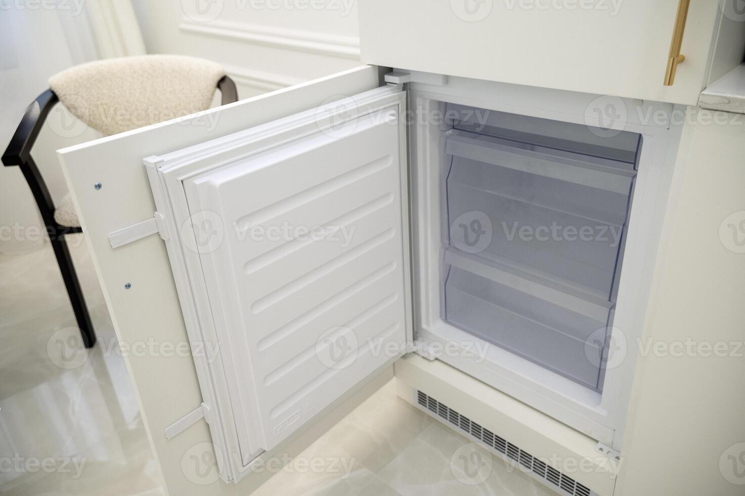open refrigerator freezer door, empty and clean. Empty built-in refrigerator after cleaning. close-up of built-in appliances. High quality photo