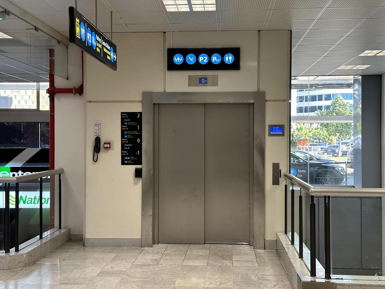 Nice, France - May 10, 2025 Elevator entrance in modern building lobby with directional signs, showcasing accessibility features and contemporary design elements for urban environments photo