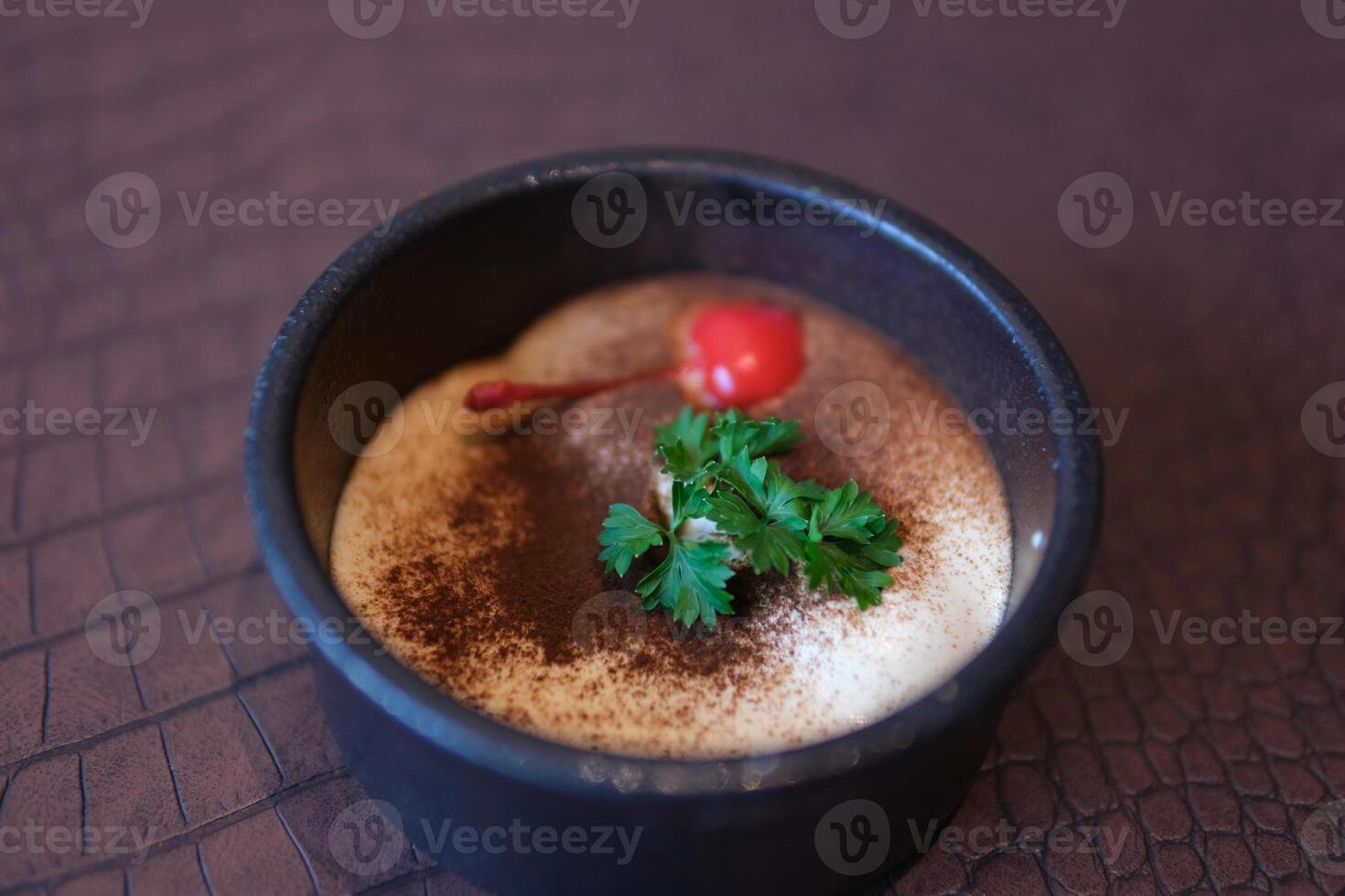 Home-made Highland Tiramisu Creme Perfect ready-to-eat homemade tiramisu cake with fresh mint. Tiramisu portion on pink plate over white marble background. Delicious photo