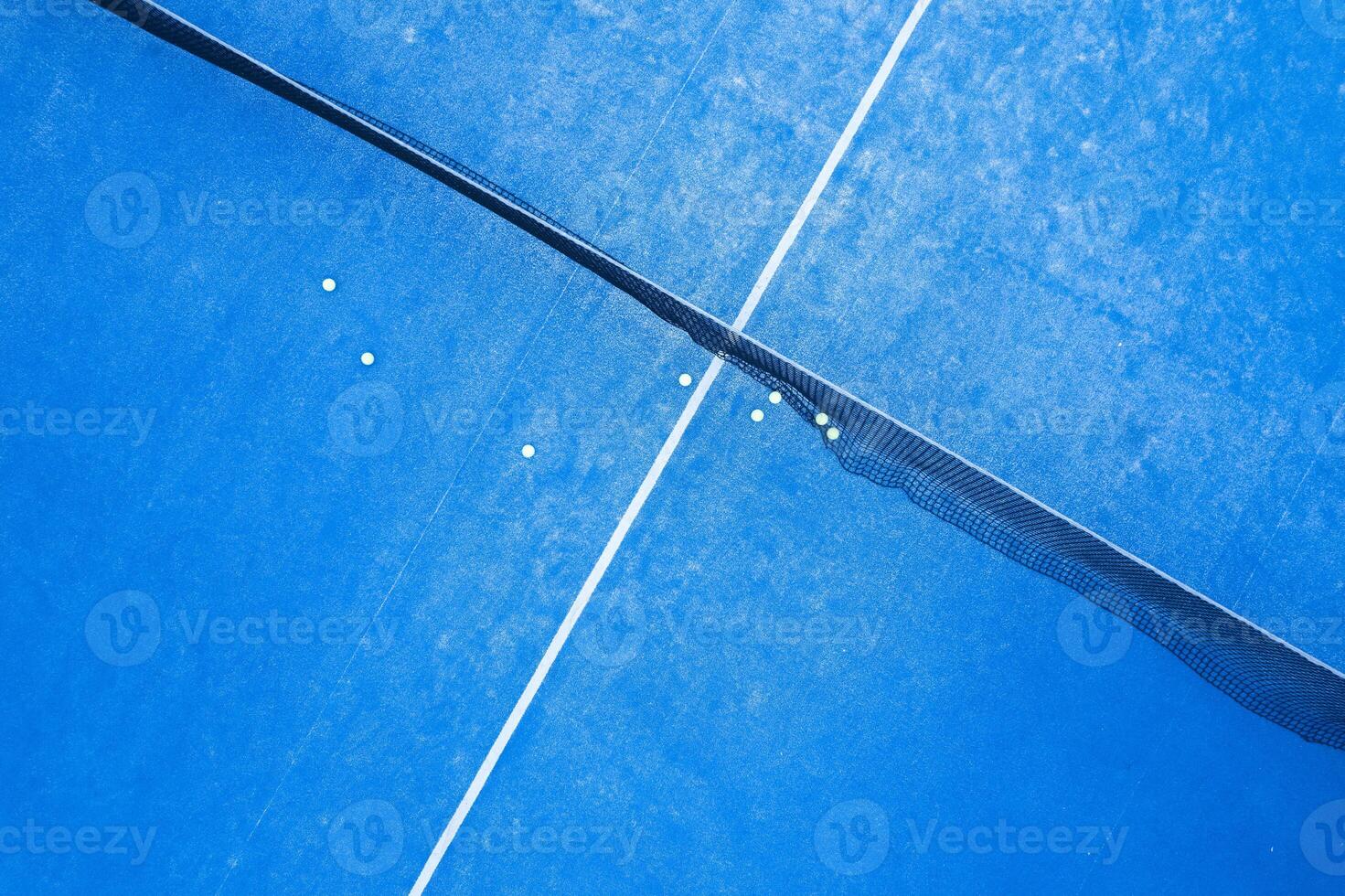 Padel Balls on a Vibrant Blue Court, Ready for a Game or Training photo