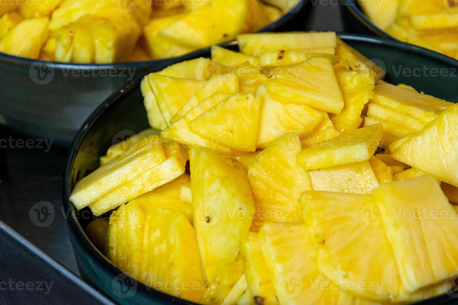 close up of sliced pineapple, healthy food preparation process photo