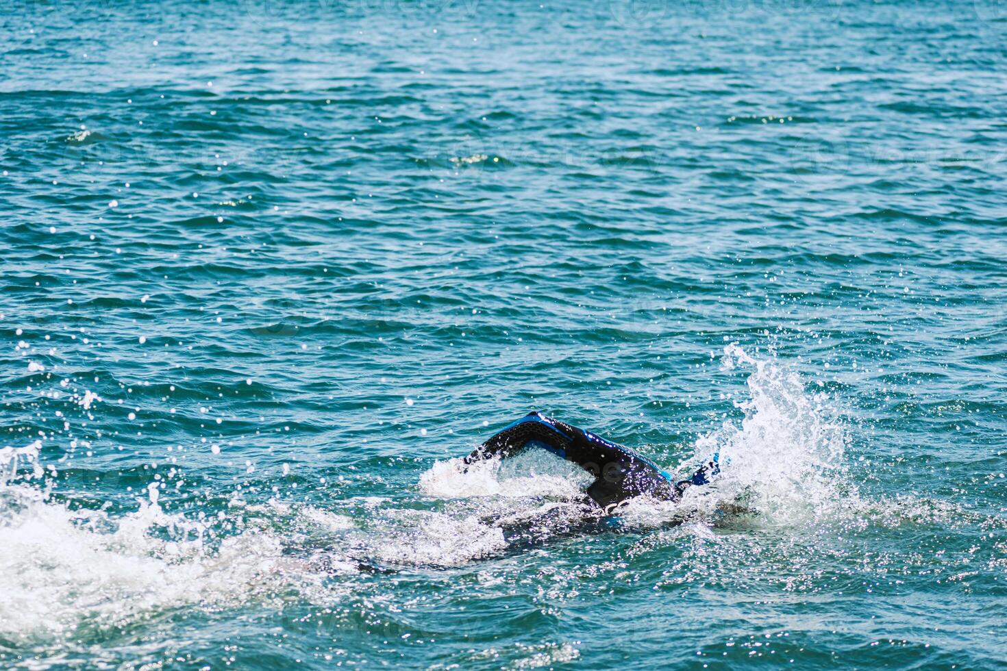 An Athlete Competing in an Open Water Swimming Race in the Sea photo
