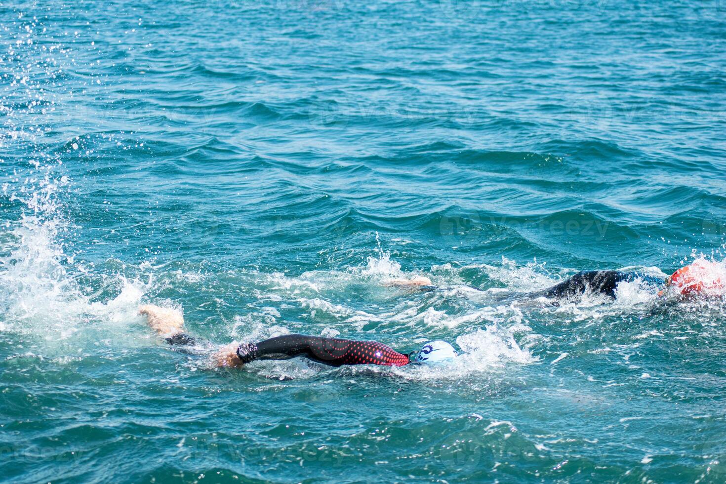 two swimmers in the swimming event in a triathlon competition photo