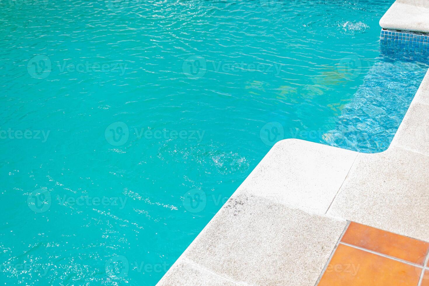 close up of clear blue pool water with bubbling effects and mosaic tiles photo
