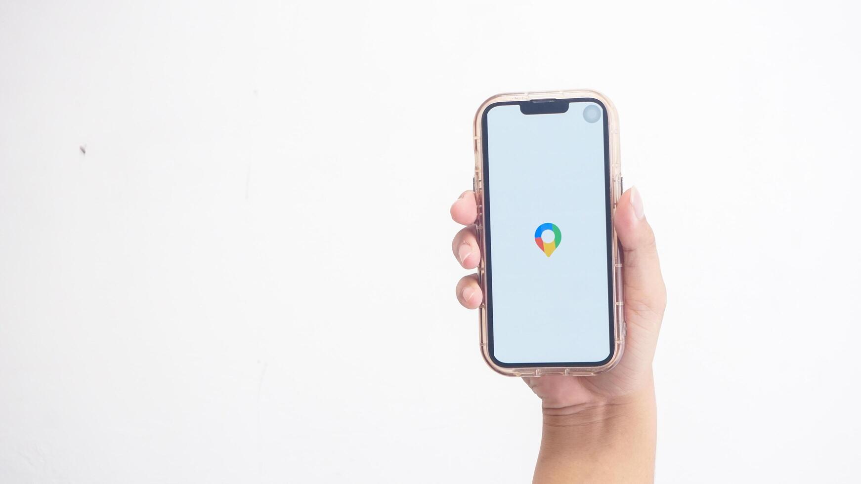 Yogyakarta, Indonesia, 2025 - Hand holdingHand holding smartphone that shows Google application logo, a search engine platform, on screen isolated on white background photo