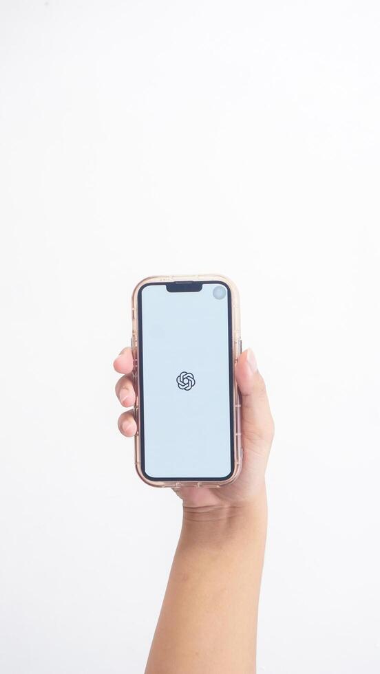 Yogyakarta, Indonesia, 2025 - Hand holdingHand holding smartphone that shows front page of ChatGPT application, an artificial intelligence platform, on screen isolated on white background photo