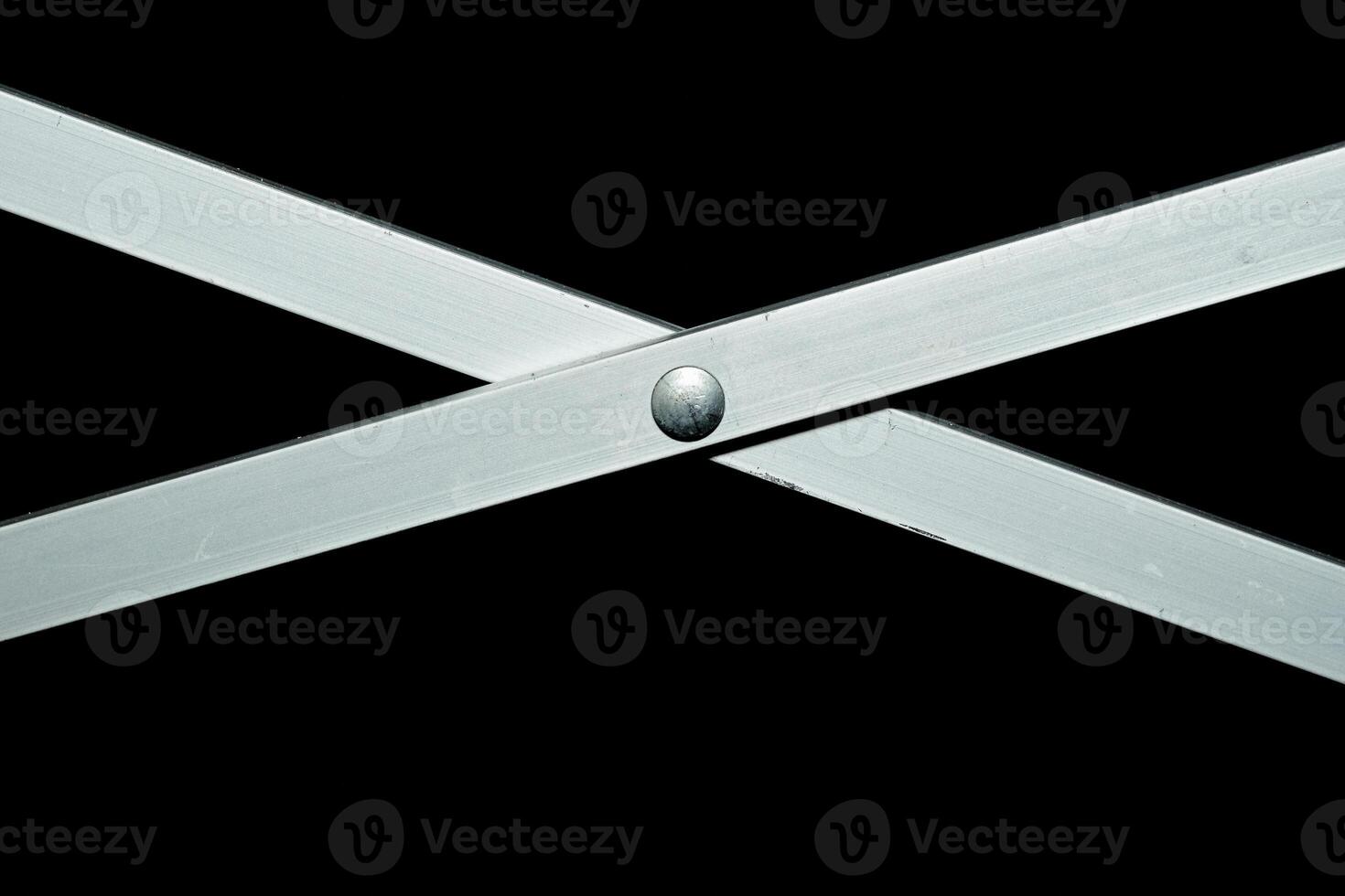 X shaped metal sliding folding crossbar on black photo