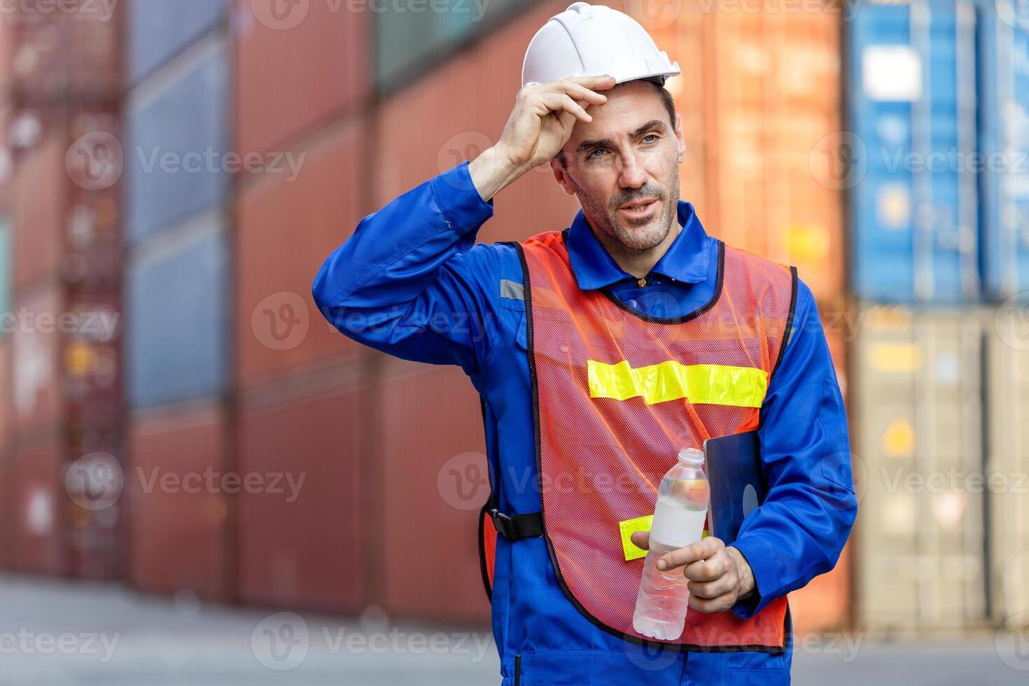 Worker man in hard hat with drinking water bottle, Construction worker drinking water from bottle photo