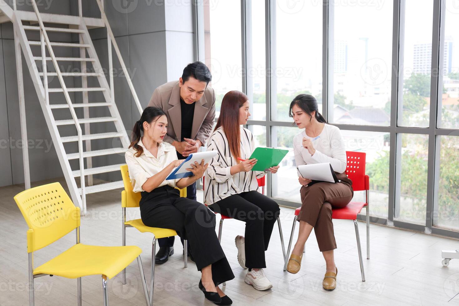 Diverse Business Team Brainstorming and Discussing Ideas, Young Asian Professionals Collaborating in Modern Office, Casual Business Meeting, Colleagues Sharing Insights photo