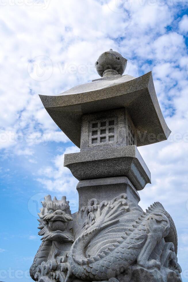 Dragon-carved stone lantern - Toro - in Enoshima Island, Japan photo