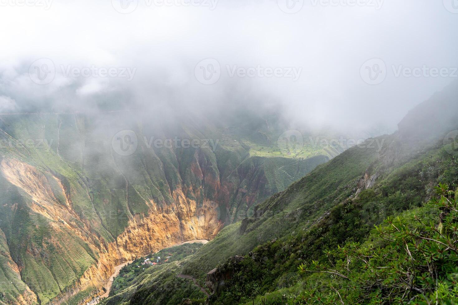 The Colca Canyon and river in the mist and clouds, Peru photo