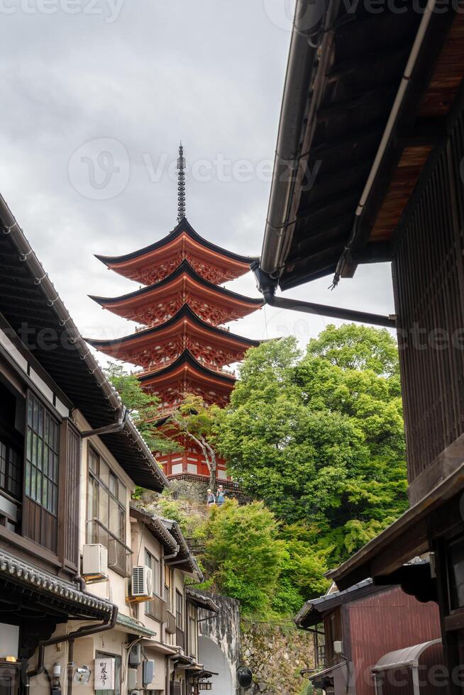Gojunoto five-storied pagoda seen from traditional Miyajima street photo