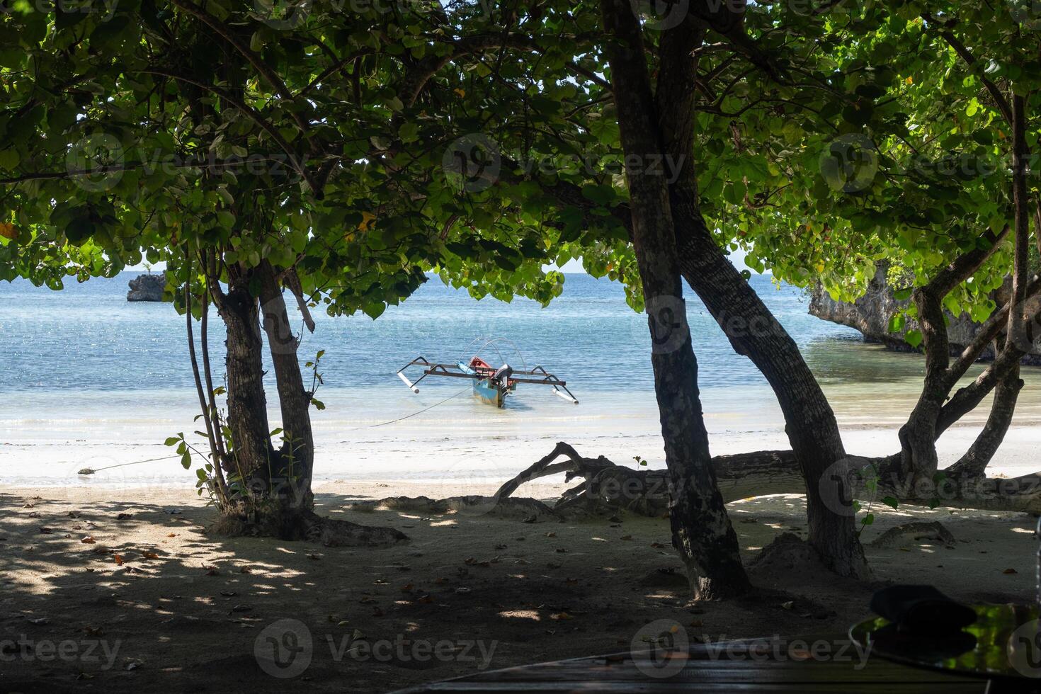 A Traditional boat on Lia beach, Waleakodi Island, Togian archipelago, Sulawesi, Indonesia photo