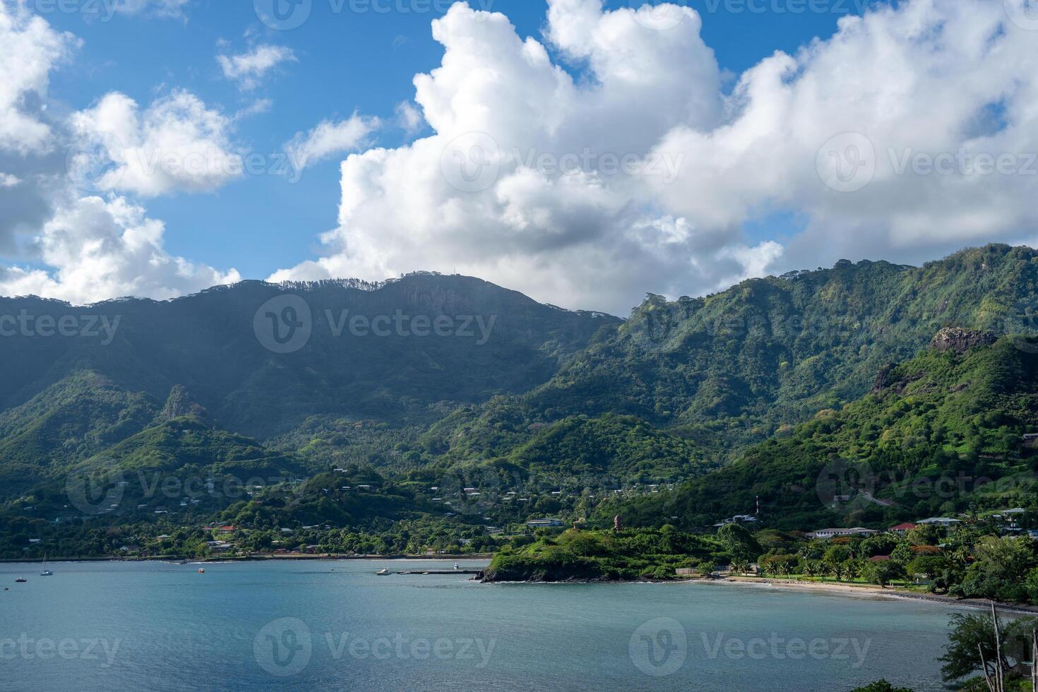 The Taiohae Bay and town with anchored sailboats in Nuku Hiva, Marquesas Islands, French Polynesia photo
