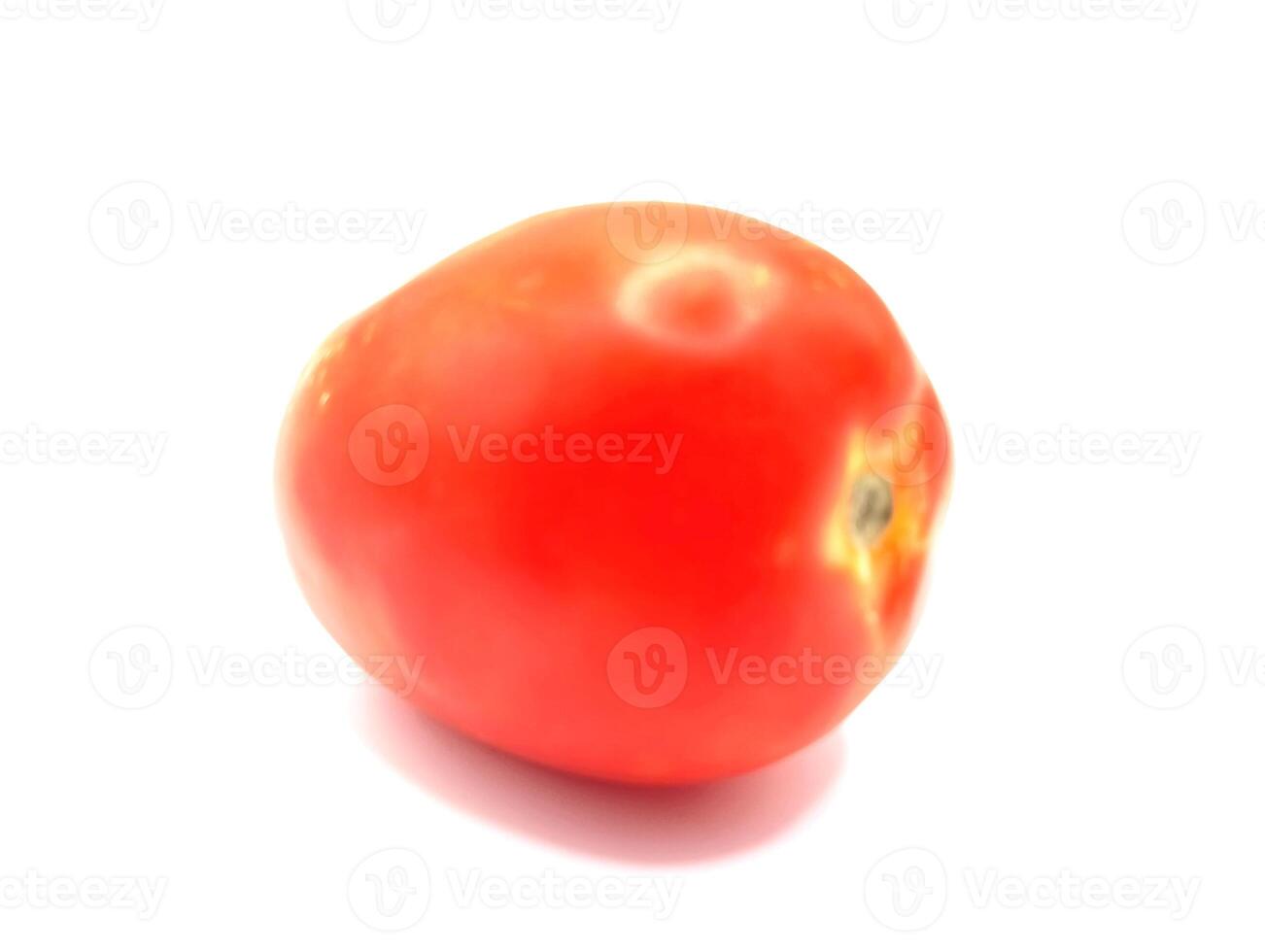 Fresh vibrant, ripe red tomato isolated on a white surface. photo