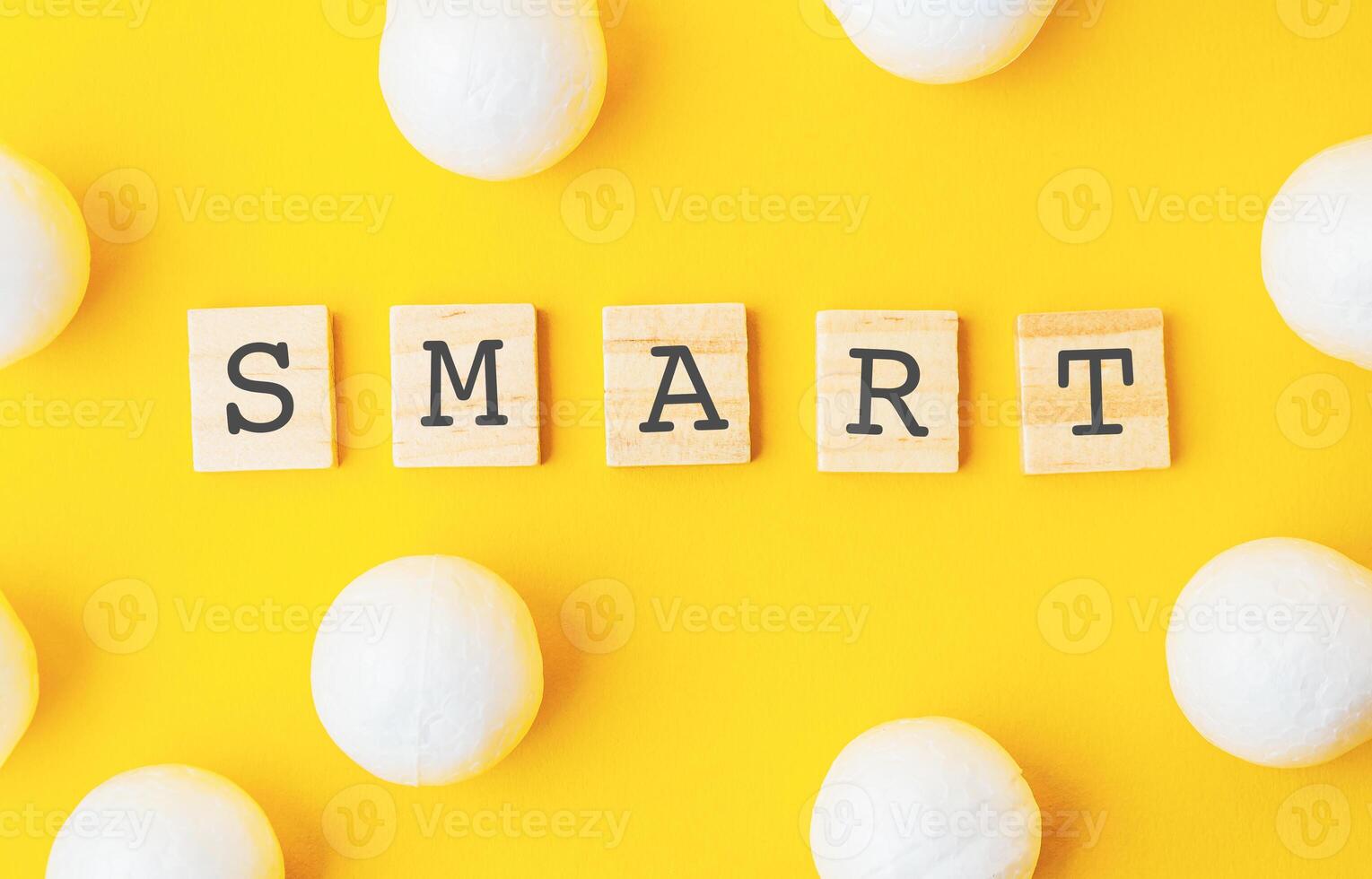 Yellow background with a large white word smart written in black letters photo