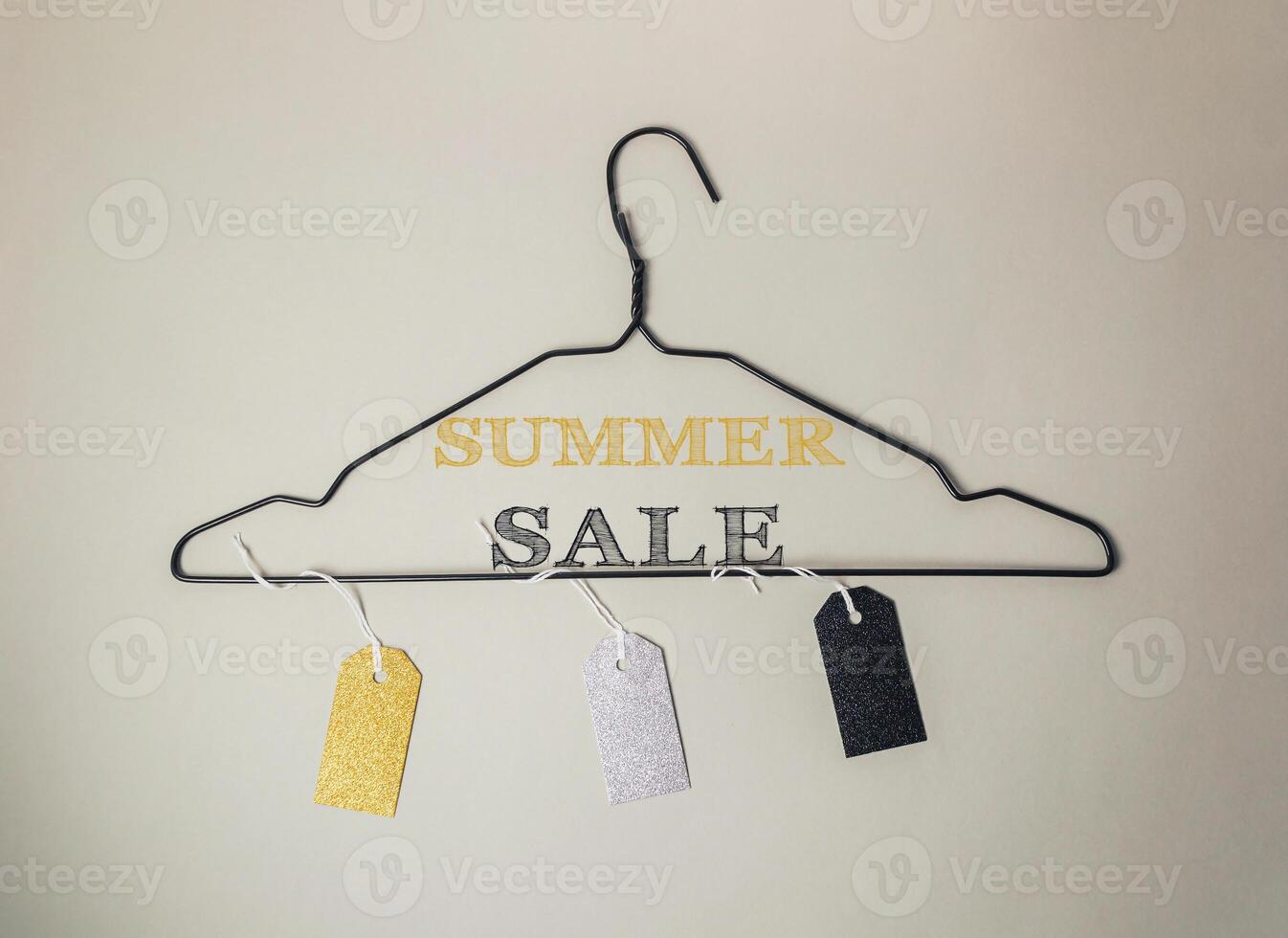 Clothes hanger with tags on it that say Summer Sale photo