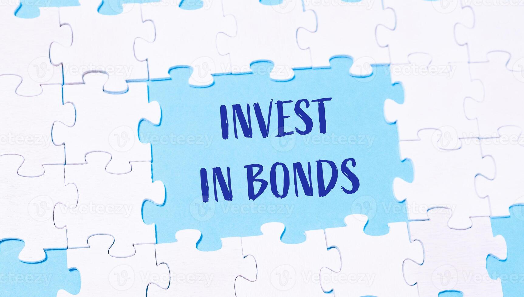 Jigsaw puzzle with the words invest in bonds written in blue photo