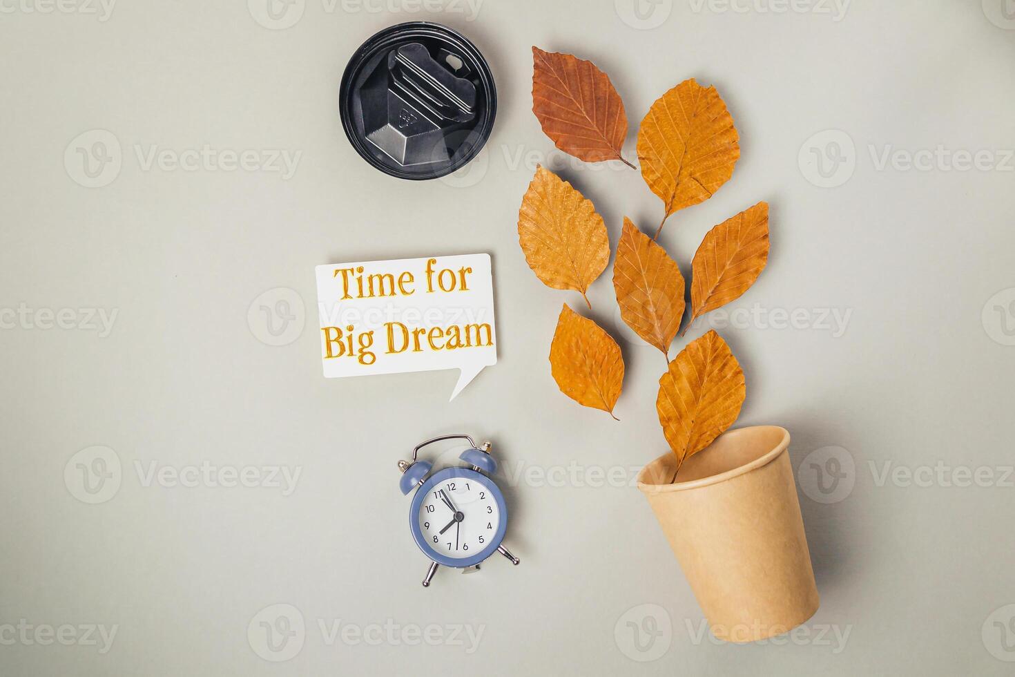 Clock and cup with leaves on it photo