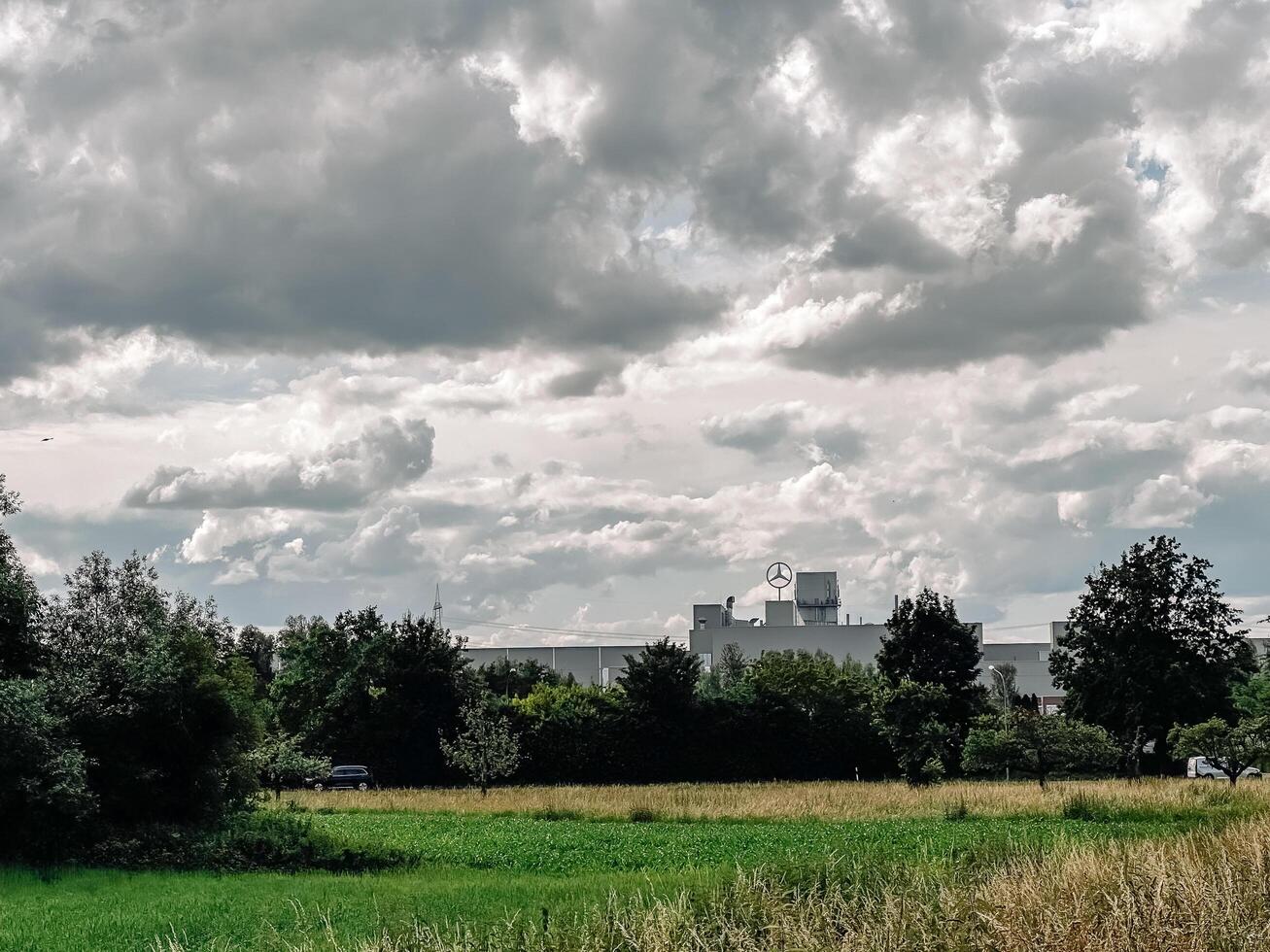 Rastatt, Germany - June 11, 2024 - In the background you can see a large Mercedes car factory. photo