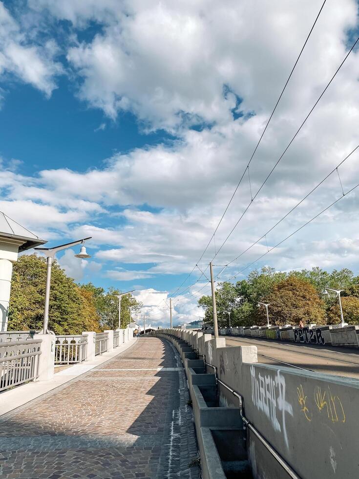 Freiburg, Germany - August 20, 2022 - Street with a bridge and a few trees photo