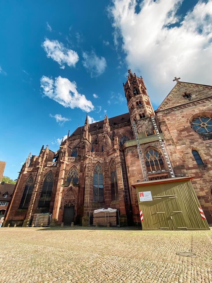 Freiburg, Germany - August 20, 2022 - Large church with a red and white sign on the side photo